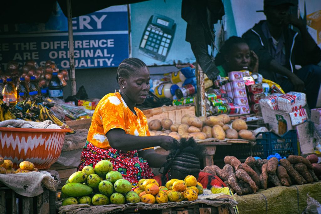 Colorful bustling market scene in Monrovia with local vendors selling fresh produce and goods in Liberia.